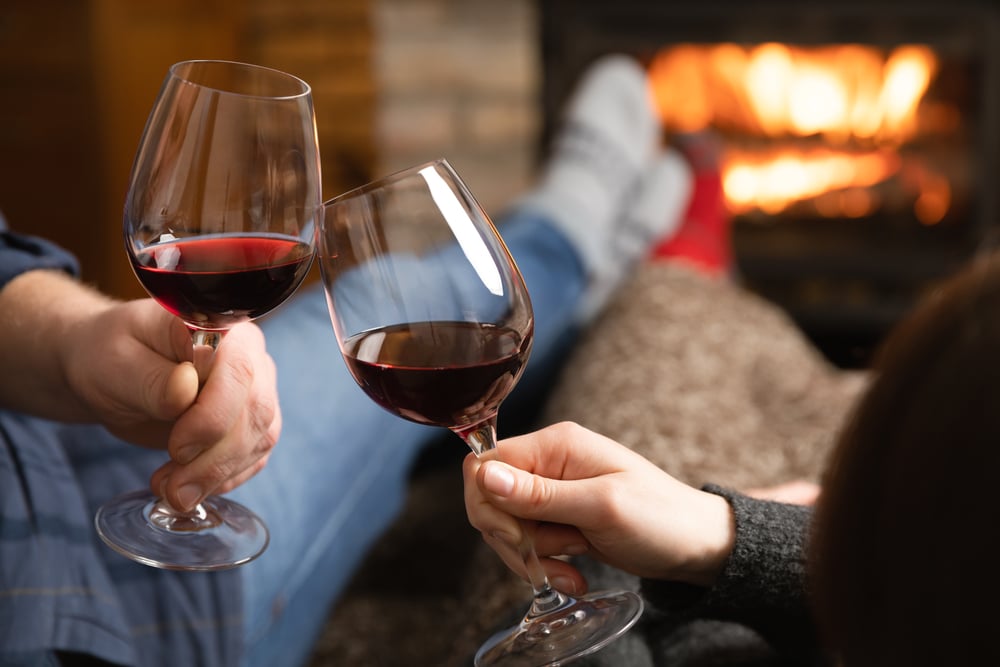 enjoy a glass of red wine by the fire during romantic getaways in Wisconsin