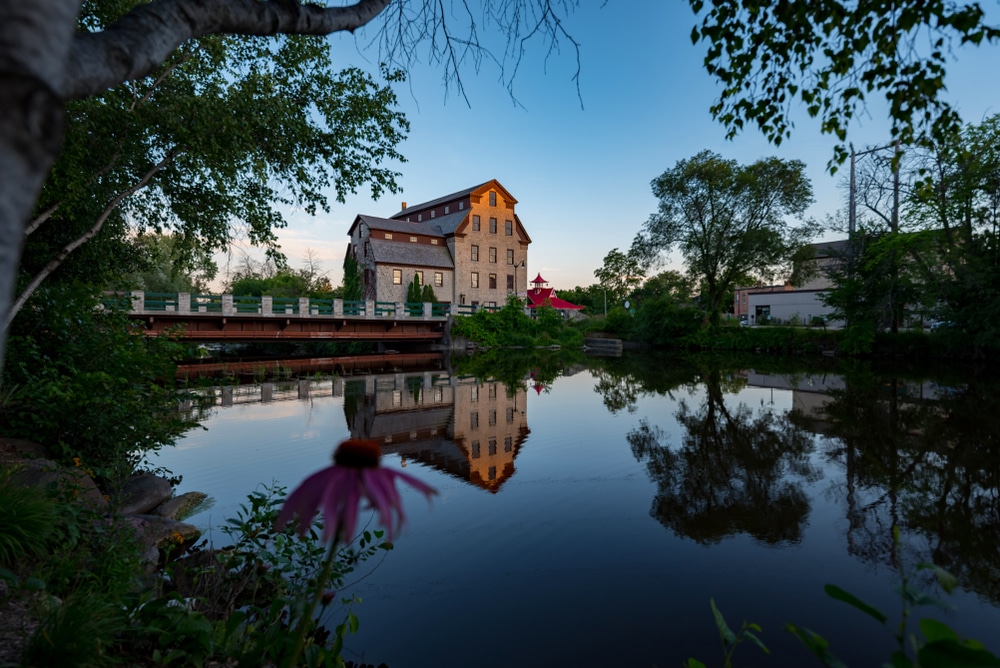 A reflected view over the water of the Old Mill one of the top things to do in Cedarburg, WI