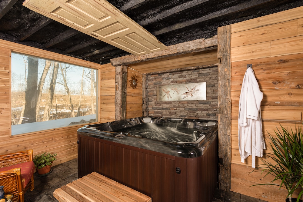 Warm up in this hot tub with a view of our property during your Wisconsin winter getaway