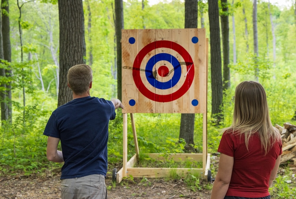 Couple axe throwing at our Wisconsin Bed and Breakfast - the best couples getaway in Wisconsin near Milwaukee