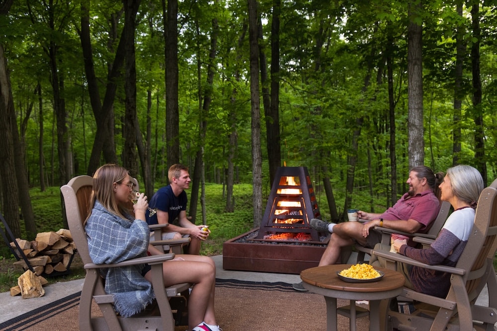 Couples talking by the fire at our Inn, the best couples getaway in Wisconsin near Milwaukee