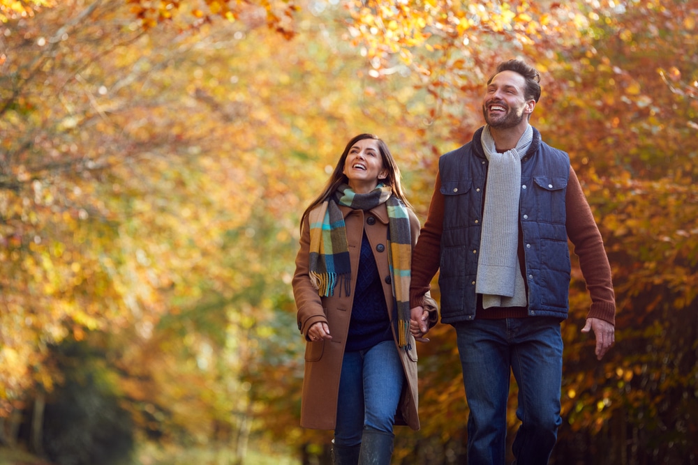 The Best Fall Getaways Near Chicago 8 Couple hiking in the woods during their fall getaways near Chicago